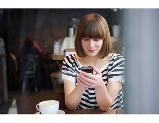 Slika lahko vsebuje Človeška elektronika, telefon, ženski mobilni telefon, mobilni telefon, obraz, skodelica za kavo in skodelica
