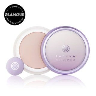 Una crema de color rosa violeta claro encerrada en un recipiente de color violeta pastel con un pequeño disco violeta para ser utilizado para la aplicación ....