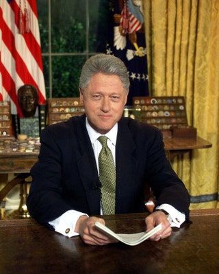 La imagen puede contener Bill Clinton Persona humana Sentada Ropa Traje Abrigo Abrigo Ropa Corbata y accesorios