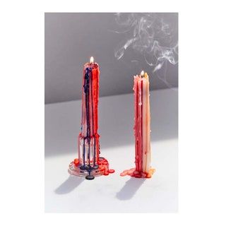 Velas encendidas de colores con cera goteando
