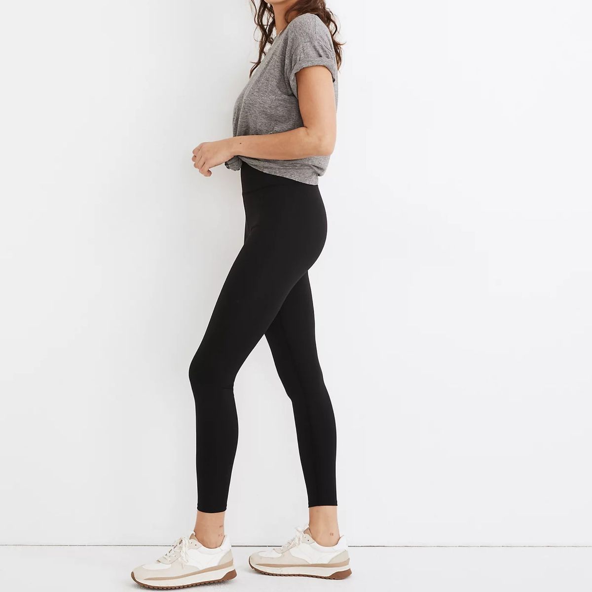 Model trägt schwarze Leggings und graues T-Shirt